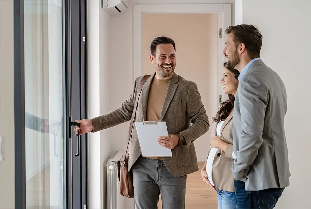 Man introducing couple to a new home in Portland